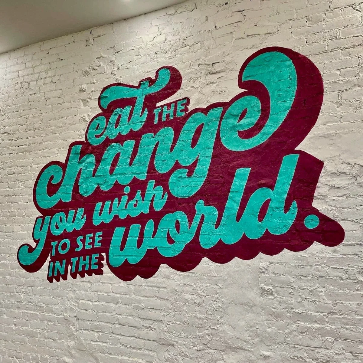 Eat the change you wish to see in the world lettering mural