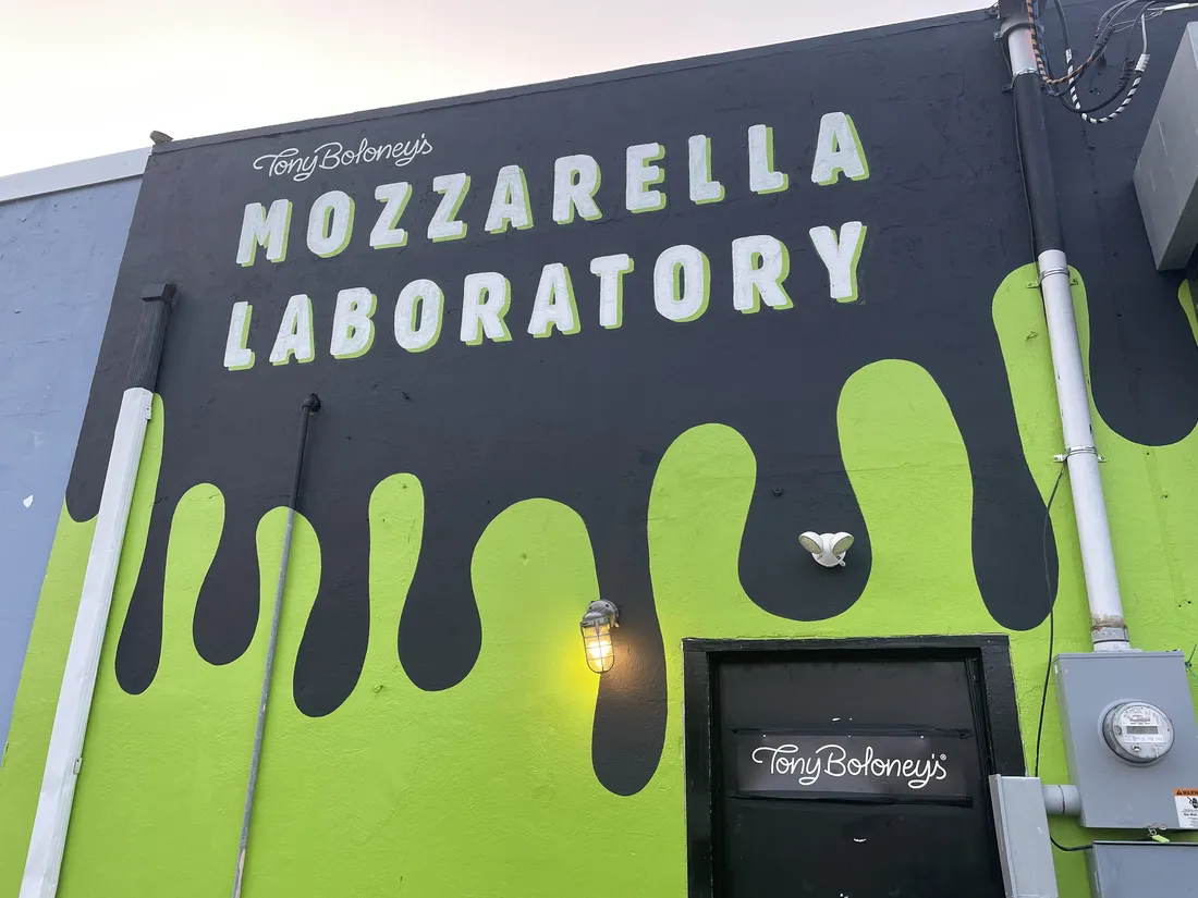 Mozzarella Laboratory green drip storefront brand mural