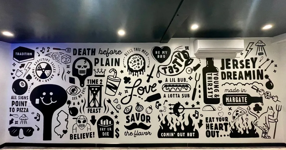 Typographic word collage mural in black and white