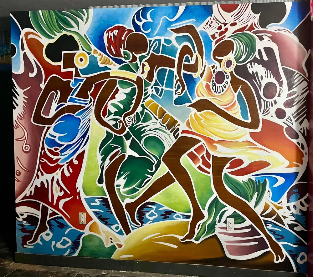 Colorful mural of dancing figures in motion