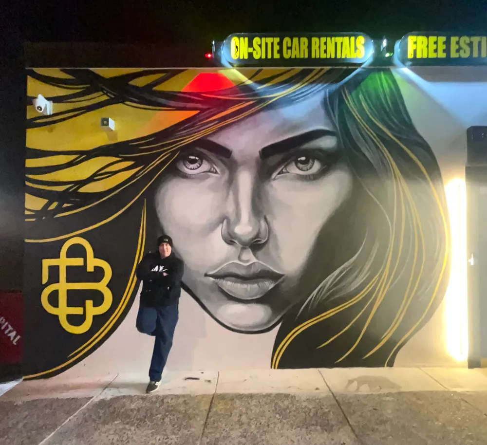 Portrait mural of a woman in a red hat